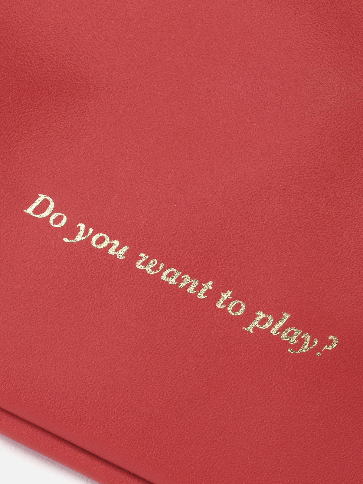 Detalle de "Do you want to play?" grabado en dorado sobre piel roja – Mercules Backgammon Club